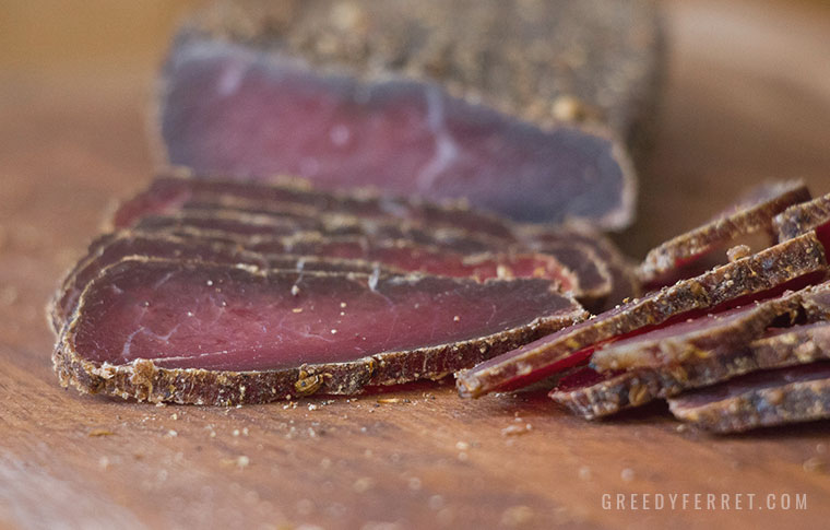 Wet biltong slices on a chopping board